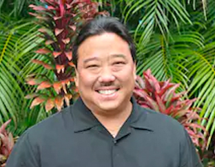 A man with black shirt and brown hair.