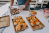 A person putting food on top of two trays.