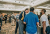 A group of people standing around each other.
